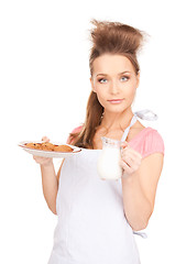 Image showing housewife with milk and cookies