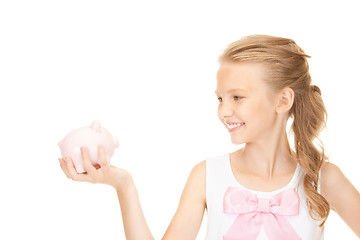 Image showing lovely teenage girl with piggy bank