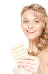 Image showing young woman with pills