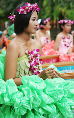 Image showing Beautiful Thai girl with orchids in her hair during in a parade,