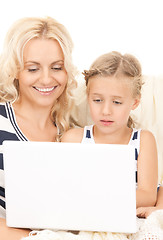 Image showing happy mother and child with laptop computer
