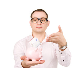 Image showing businessman with piggy bank and money