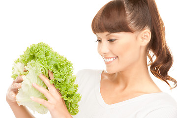 Image showing beautiful housewife with lettuce over white