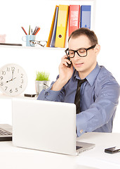 Image showing businessman with laptop computer in office