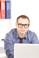 Image showing businessman with laptop computer in office