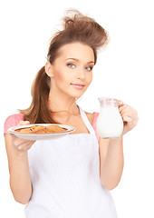 Image showing housewife with milk and cookies