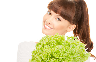 Image showing beautiful housewife with lettuce over white