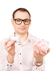 Image showing businessman with piggy bank and money