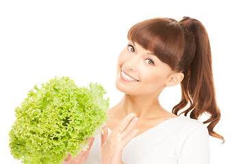 Image showing beautiful housewife with lettuce over white