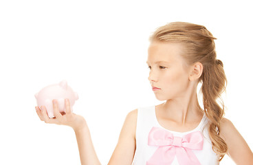 Image showing lovely teenage girl with piggy bank