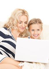 Image showing happy mother and child with laptop computer