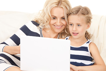 Image showing happy mother and child with laptop computer