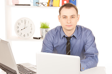 Image showing businessman with laptop computer in office