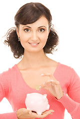 Image showing lovely woman with piggy bank and money