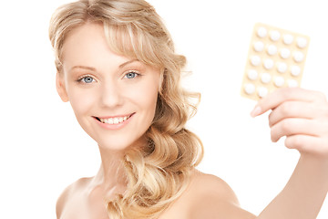 Image showing young woman with pills