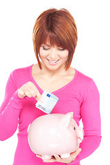 Image showing lovely woman with piggy bank and money