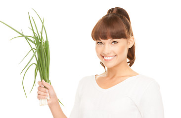 Image showing beautiful housewife with spring onions over white