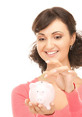 Image showing lovely woman with piggy bank and money