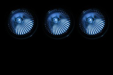 Image showing Three halogen spotlights in blue