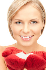 Image showing beautiful woman in red mittens with snow