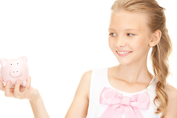 Image showing lovely teenage girl with piggy bank