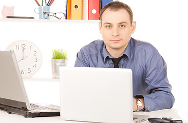Image showing businessman with laptop computer in office