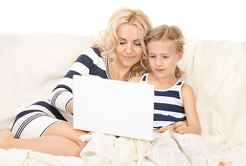 Image showing happy mother and child with laptop computer