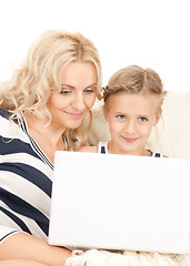 Image showing happy mother and child with laptop computer