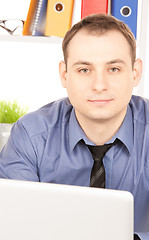 Image showing businessman with laptop computer in office