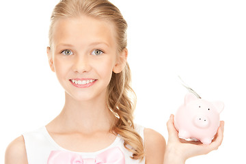 Image showing lovely teenage girl with piggy bank and money