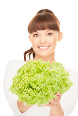 Image showing beautiful housewife with lettuce over white