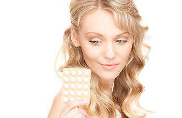 Image showing young woman with pills