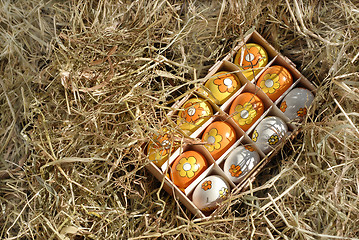 Image showing easter-eggs in box in hay