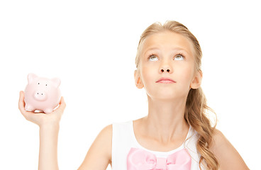 Image showing lovely teenage girl with piggy bank