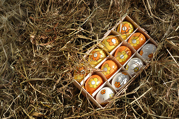 Image showing easter-eggs in box in hay