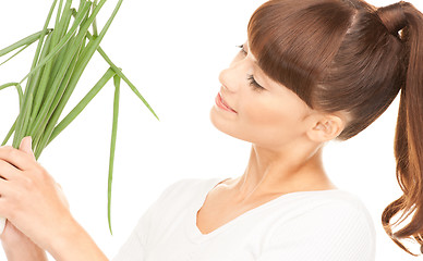 Image showing beautiful housewife with spring onions over white