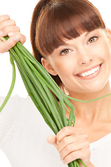Image showing beautiful housewife with spring onions over white