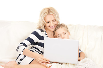 Image showing happy mother and child with laptop computer