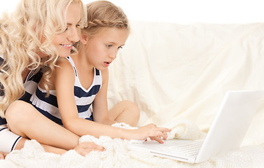 Image showing happy mother and child with laptop computer