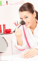 Image showing lovely woman with brush and mirror