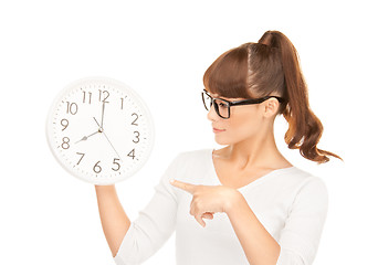 Image showing woman holding big clock