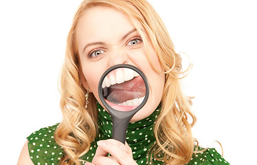 Image showing woman with magnifying glass showing teeth