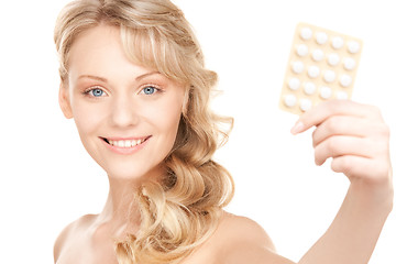 Image showing young woman with pills