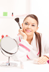 Image showing lovely woman with brush and mirror