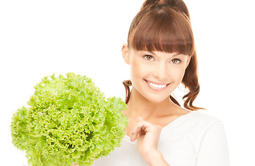 Image showing beautiful housewife with lettuce over white