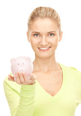 Image showing woman with piggy bank