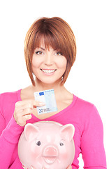 Image showing lovely woman with piggy bank and money