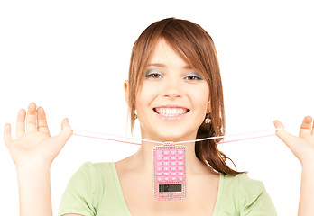 Image showing lovely teenage girl with calculator