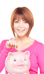 Image showing lovely woman with piggy bank and money