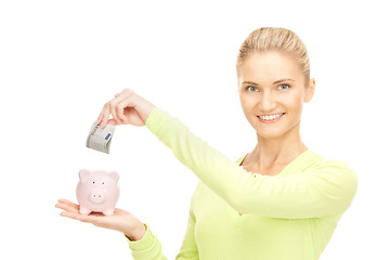 Image showing woman with piggy bank and money